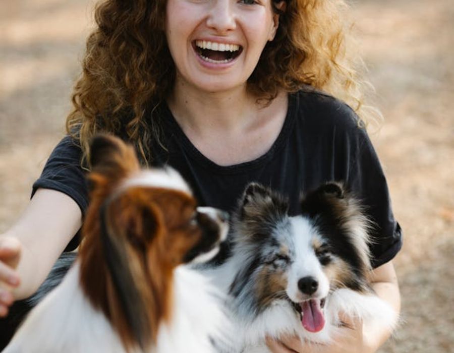 a woman cuddling her dogs